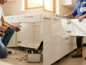 DIY vs pro kitchen cabinet installation: homeowner measuring and aligning cabinet panels.