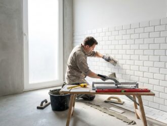 Newly tiled bathroom floor and walls with DIY tools, illustrating a home tiling project.