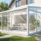 Modern glass conservatory addition linking indoor living space with garden views