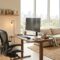 Modern home office with sleek desk, ergonomic chair, natural light, showing post‑pandemic design