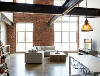 Industrial loft living room in modern home with exposed brick steel beams and vintage furnishings