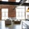 Industrial loft living room in modern home with exposed brick steel beams and vintage furnishings