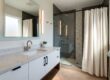 Modern bathroom with sleek fixtures, new vanity, stylish lighting and contemporary accessories