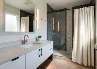 Modern bathroom with sleek fixtures, new vanity, stylish lighting and contemporary accessories