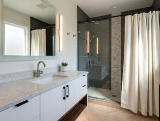 Modern bathroom with sleek fixtures, new vanity, stylish lighting and contemporary accessories