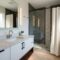 Modern bathroom with sleek fixtures, new vanity, stylish lighting and contemporary accessories